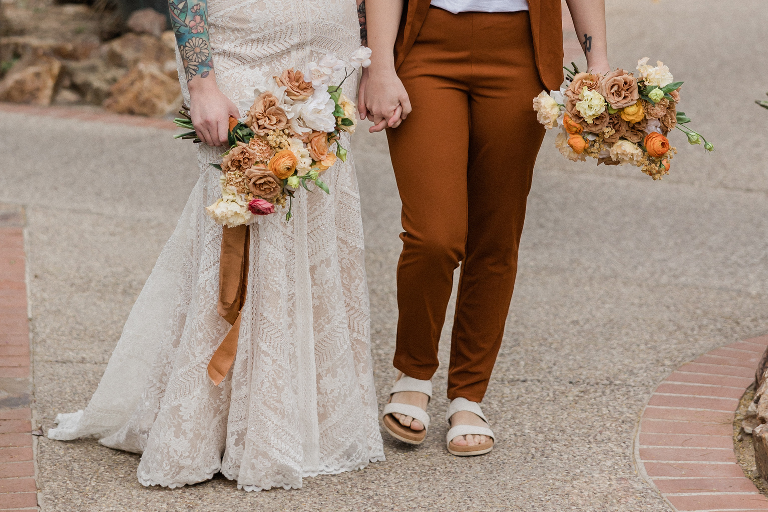 Newlywed Couple Holding Hands Walking at the Pavement
